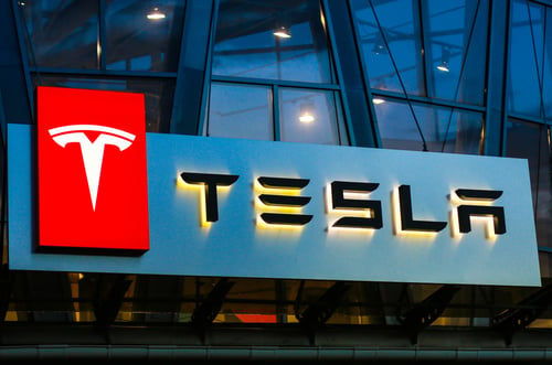 Illuminated Tesla sign at night